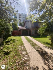 a house with a pathway in front of a building at ANEMONE in Villa Gesell