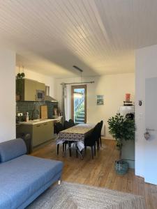 a living room with a table and a kitchen at Maison Pyrénées in Saint-Aventin