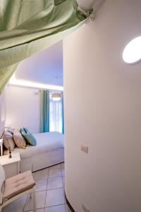 a small bedroom with a bed and a couch at Loft 12/A in Modugno