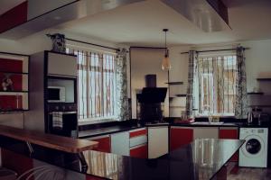 a kitchen with red and white cabinets and a microwave at Trou aux Biches Serenity in Pointe aux Biches