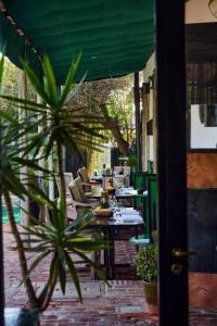 un patio con mesas, sillas y una planta en Hotel Garzón, en Garzón