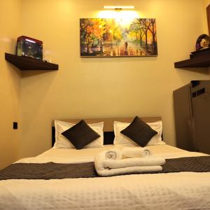 a bedroom with a bed with towels on it at Cozy 1bhk with Terrace. in Lucknow