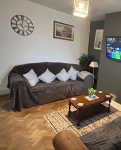 a living room with a couch and a table at West Street House in Crewe