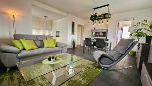 a living room with a couch and a glass table at Bellavista Apartment with Free Parking in Lugano