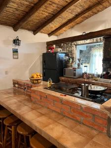 a kitchen with a counter with a stove top oven at Mi casita de Los Andes in San Rafael