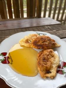 a white plate with food on a table at GUEST HOUSE “ Center Theth “ in Theth