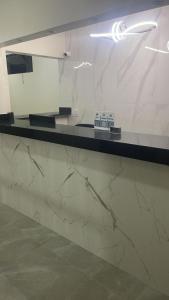 a marble counter in a room with a mirror at Hotel Urban in São Paulo +44 photos