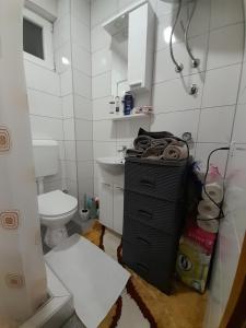 a white bathroom with a toilet and a sink at Markov Konak in Foča
