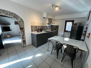 a kitchen and dining room with a table and chairs at Appartamento Nido Del Lago in Lenno