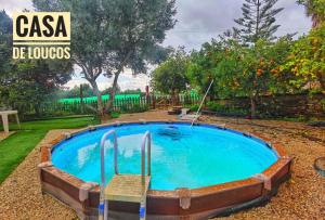 a small pool in a yard with at Bell Tent Lovers by Casa das Artes in Luz de Tavira
