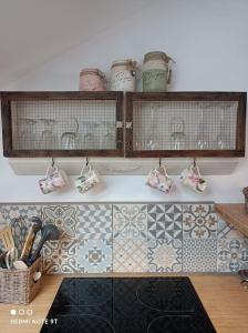 a kitchen with a counter with tiles on it at Loft atypique de charme, garage privatif in Barr