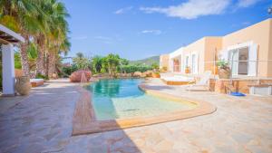 a swimming pool in the middle of a house at Villa Domino Ibiza in Sant Francesc de s'Estany