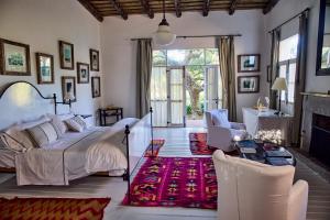 a bedroom with a bed and a living room with a fireplace at Casa Anna in Garzón