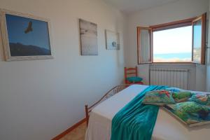 a bedroom with a bed and a window at Sea view house in Otranto 4 places in Otranto
