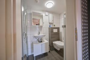 a small bathroom with a sink and a toilet at Historische Alte Mühle direkt an der Burg in Stolberg +36 photos