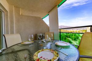 a dining room with a table with wine glasses at Apartment VilaPark with pool, free parking, terrace, beach in Benidorm