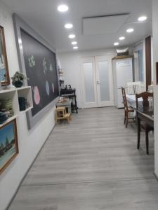 a room with a table and a chalkboard on a wall at Summer Home in Muuruvesi