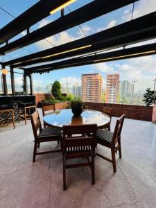 a table and chairs on a patio with a view at Napoles 2BR Zona 10 Luxury Suite - AC, Pool, Gym & View in Guatemala