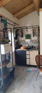 a kitchen with a counter and a stove in a room at La petite tanière in Fontan