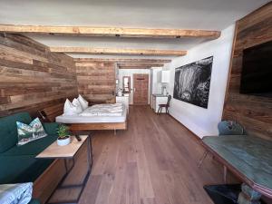 a living room with a bed and a couch at Chalet Grubhof in Sankt Martin bei Lofer