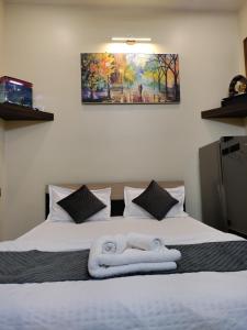 a bedroom with a bed with towels on it at Cozy 1bhk with Terrace. in Lucknow