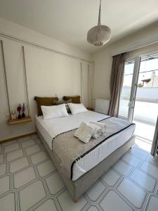 a bedroom with a large bed with towels on it at Althea Old Town Apartment in Naxos Chora