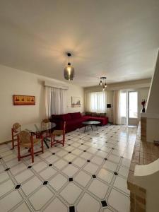 a living room with a couch and a table at Althea Old Town Apartment in Naxos Chora