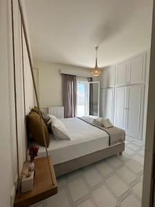 a bedroom with a bed with a swing in it at Althea Old Town Apartment in Naxos Chora