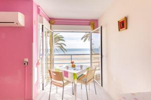 a dining room with a table and a view of the ocean at Apartamentos GEMA Primera linea Cullera in Cullera