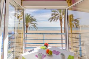 a view of the beach from the balcony of a beach house at Apartamentos GEMA Primera linea Cullera in Cullera