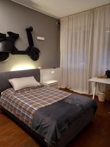 a bedroom with a bed with a motorcycle on the wall at Maison B - Locazione turistica in Brugherio