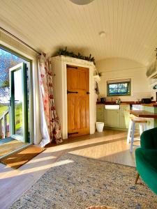 a living room with a table and a kitchen at Bailey's Hideaway in Portadown
