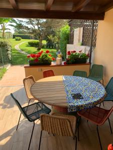 a table and chairs sitting on a porch with a table at Pelosa - Capo Falcone Excellent Apartment in Stintino