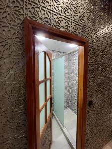 a mirror in a bathroom with a wall at Riad el wazzania in Rabat