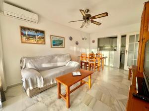 a living room with a couch and a table at Apartamento Arena y Sal in Torrox Costa