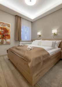 a bedroom with a large bed with two towels on it at Green District Studio Flat in Budapest