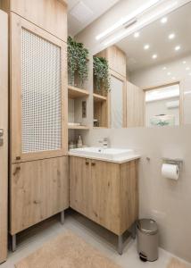 a bathroom with a sink and a mirror at Green District Studio Flat in Budapest