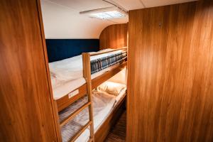 a bunk room with two bunk beds and a closet at Siocamping in Siófok