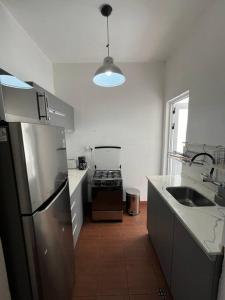 a kitchen with a stainless steel refrigerator and a sink at Apartamento en Montevideo in Montevideo