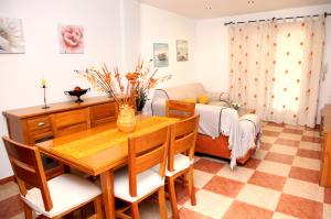 a dining room with a table and a couch at APARTAMENTO DÚPLEX VERA-GARRUCHA in Garrucha