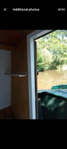 a window of a train with a view of a river at Cosy, secluded narrow boat in Airton
