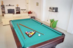 a pool table with cue balls in a living room at Foz Ocean Retreat in Foz do Arelho