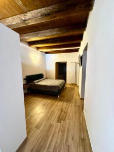 a bedroom with a bed and a wooden ceiling at Maison Costa Masciarelli in LʼAquila