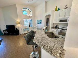 a kitchen and living room with a counter top at Villa with Pool in Gated 18-hole Golf Community with self-checkin after 4pm in Davenport