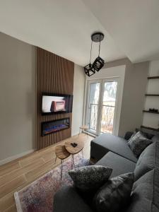 a living room with a couch and a table at Jahorina Lux in Jahorina