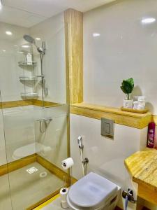 a bathroom with a shower and a toilet and a sink at Noor 2 bedroom apartment for beautiful holiday in Muscat +6 photos