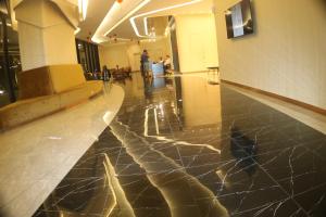 a hallway of a building with a shiny floor at Axon Service Suites At Bukit Bintang KL in Kuala Lumpur