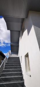 a staircase leading up to a white building at Apartments Mario in Drvar
