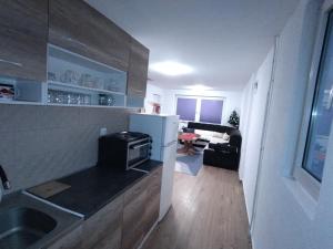 a small kitchen with a sink and a refrigerator at Kuća za odmor in Pale