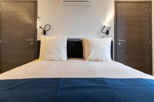 Ein Bett oder Betten in einem Zimmer der Unterkunft Li Ter Hôtel